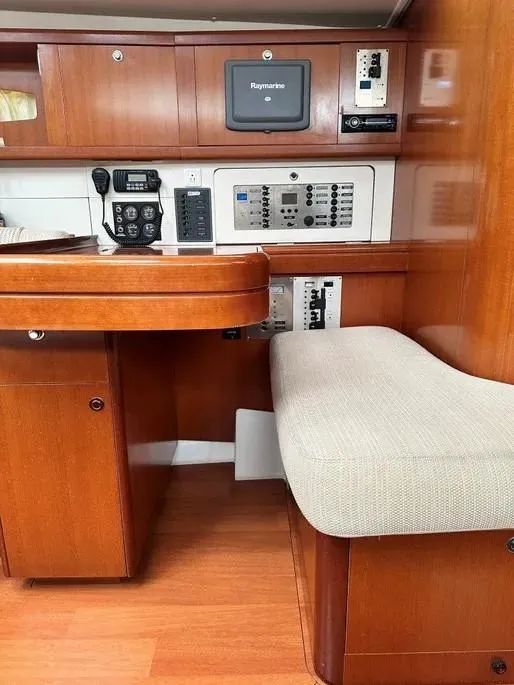 Slide: The Image of 2007 Beneteau 49' Cruiser interior with navigation equipment and seating area. - 20