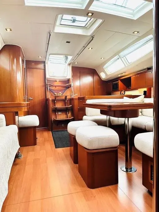 Slide: The Image of Luxurious interior of a 2007 Beneteau 49' Cruiser with elegant wood finishes. - 24