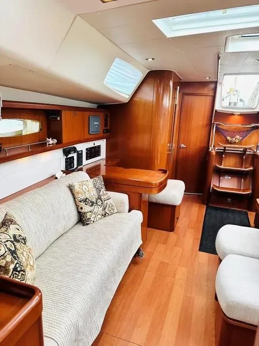 Slide: The Image of Luxurious interior of a 2007 Beneteau 49' Cruiser with elegant wood finishes and cozy seating. - 25