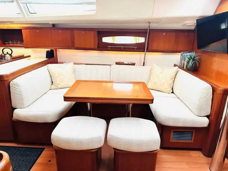 Slide: The Image of Interior of 2007 Beneteau 49' Cruiser with cozy seating and wooden table. - 26