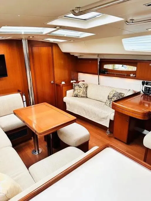 Slide: The Image of Luxurious interior of a 2007 Beneteau 49' Cruiser yacht with elegant wood finishes. - 30