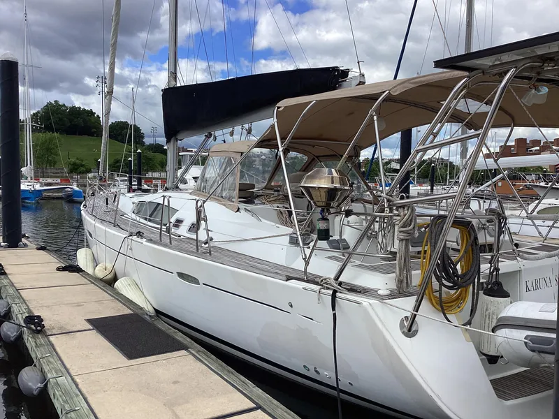 Slide: The Image of 2007 Beneteau 49' Cruiser yacht docked at marina under cloudy sky. - 34