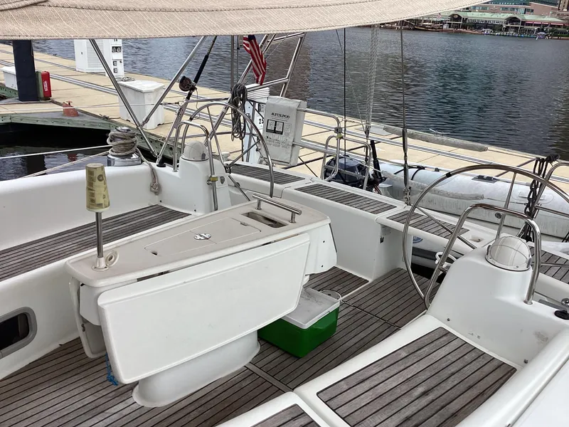 Slide: The Image of 2007 Beneteau 49' Cruiser sailboat cockpit with teak flooring and marina view. - 35