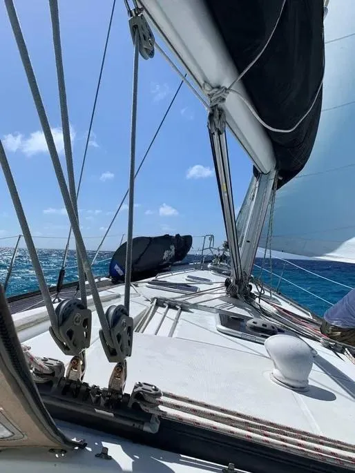 Slide: The Image of 2007 Beneteau 49' Cruiser sailing on open sea under clear blue skies. - 4