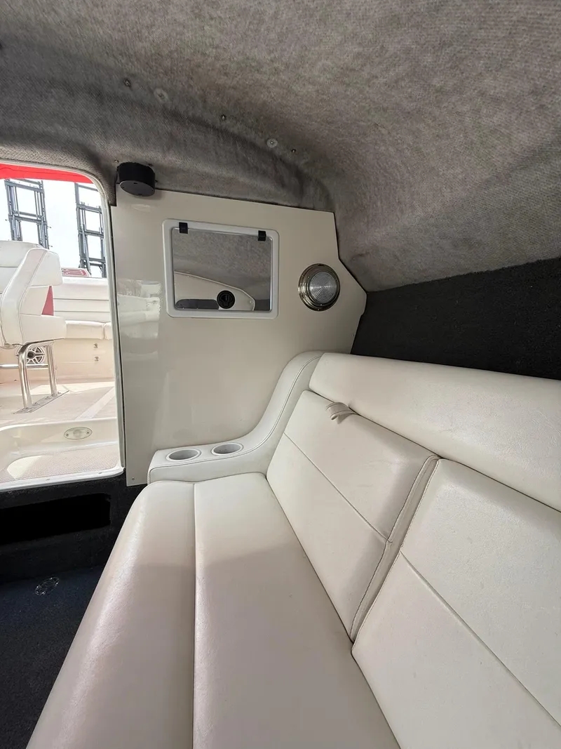 Slide: The Image of Interior of a 2003 Lavey Craft 2750 NUERA boat with white seating. - 15