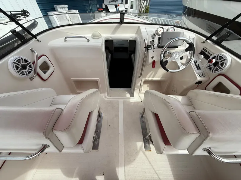 Slide: The Image of 2003 Lavey Craft 2750 NUERA boat interior with white seating and steering console. - 20