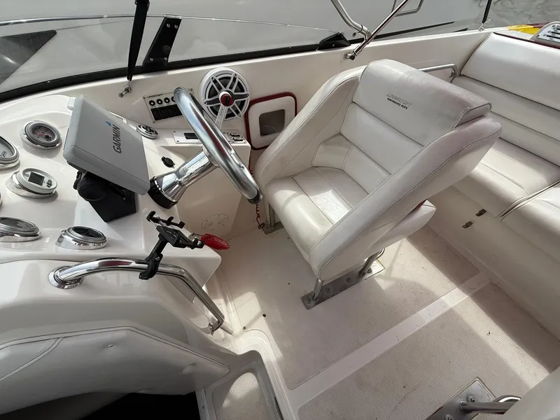Slide: The Image of 2003 Lavey Craft 2750 NUERA boat cockpit with white leather seating and control panel. - 22