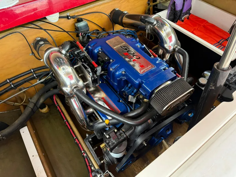 Slide: The Image of 2003 Lavey Craft 2750 NUERA boat engine, featuring a powerful blue motor with chrome components. - 26