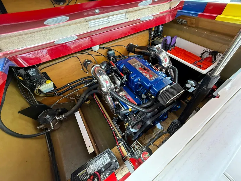Slide: The Image of Engine compartment of a 2003 Lavey Craft 2750 NUERA boat, featuring a powerful motor. - 27