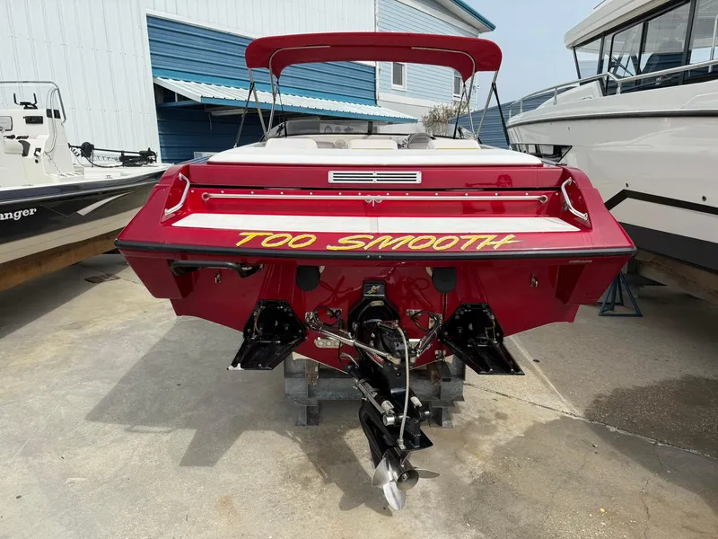 Slide: The Image of 2003 Lavey Craft 2750 NUERA boat, red with "Too Smooth" text, docked at marina. - 3