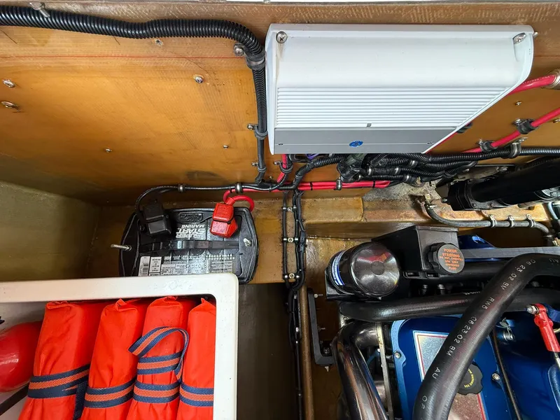 Slide: The Image of 2003 Lavey Craft 2750 NUERA engine compartment with battery, wiring, and safety equipment. - 31