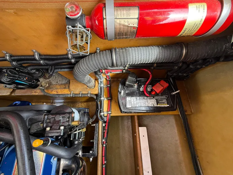 Slide: The Image of Engine compartment of a 2003 Lavey Craft 2750 NUERA with fire extinguisher and battery. - 32