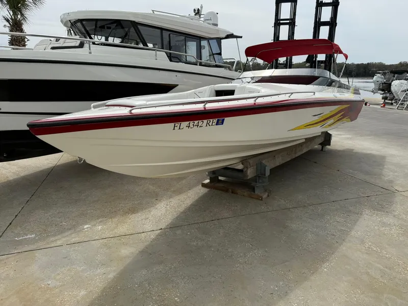 Slide: The Image of 2003 Lavey Craft 2750 NUERA boat with red accents, docked on a concrete surface. - 5