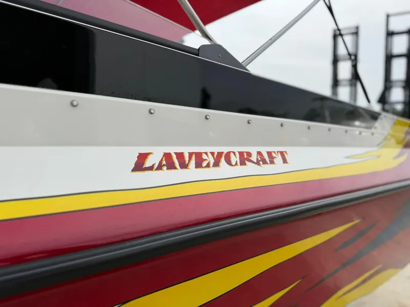 Slide: The Image of 2003 Lavey Craft 2750 NUERA boat with vibrant red and yellow design. - 8