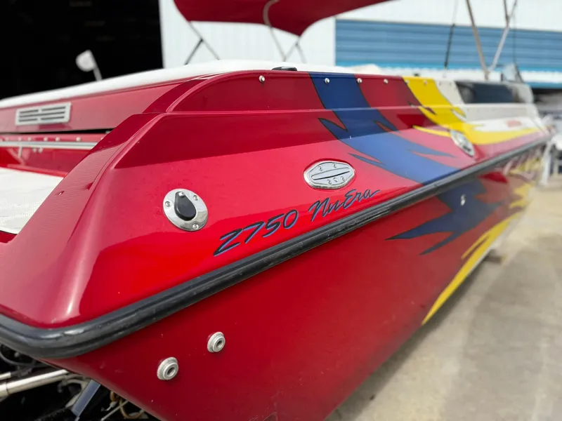 Slide: The Image of 2003 Lavey Craft 2750 NUERA boat with vibrant red and yellow design. - 9