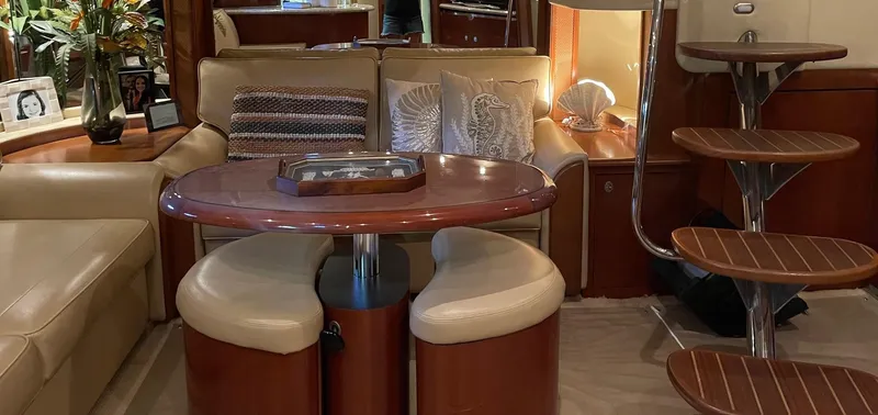 Slide: The Image of Interior of 2005 Sea Ray 500 Sundancer with elegant seating and wooden table. - 12