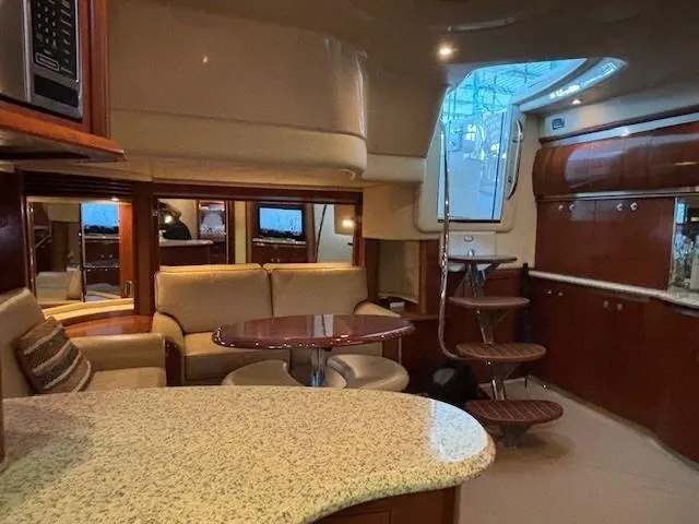 Slide: The Image of Luxurious interior of a 2005 Sea Ray 500 Sundancer yacht with elegant seating and wooden finishes. - 26