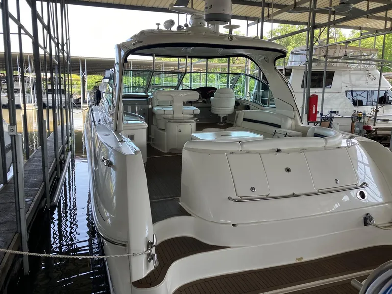 Slide: The Image of 2005 Sea Ray 500 Sundancer yacht docked in marina, showcasing spacious deck and seating area. - 3