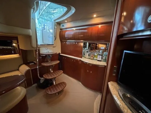 Slide: The Image of Luxurious interior of a 2005 Sea Ray 500 Sundancer yacht with elegant wood finishes. - 33
