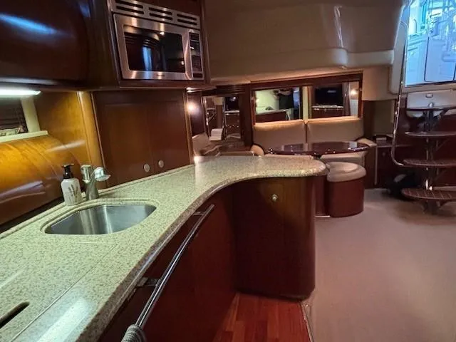 Slide: The Image of Luxurious interior of a 2005 Sea Ray 500 Sundancer yacht with modern kitchen amenities. - 36