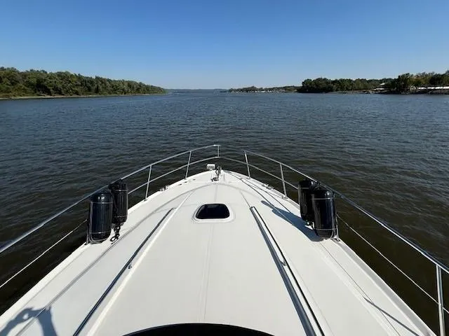 Slide: The Image of 2005 Sea Ray 500 Sundancer cruising on a calm river under clear blue skies. - 38