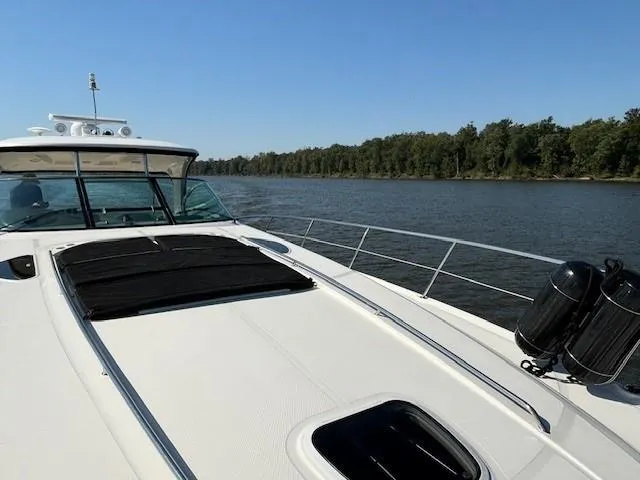 Slide: The Image of 2005 Sea Ray 500 Sundancer yacht cruising on a calm river with forested shoreline. - 42