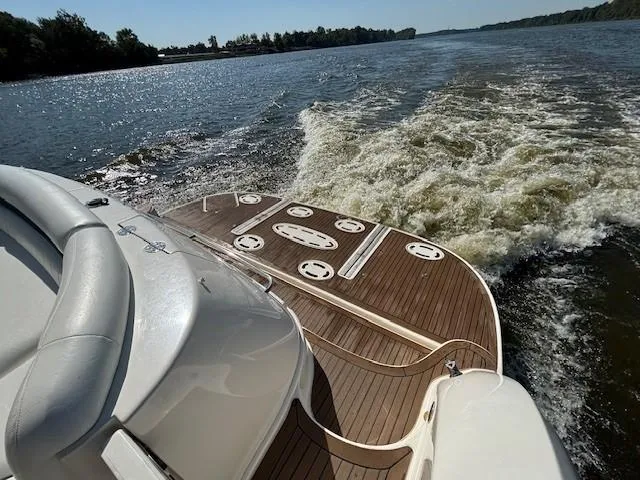 Slide: The Image of 2005 Sea Ray 500 Sundancer cruising on a sunny day, showing elegant teak deck. - 46