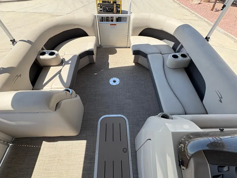 Slide: The Image of 2019 Bennington 23 SXP pontoon boat interior with beige seating and cup holders. - 12