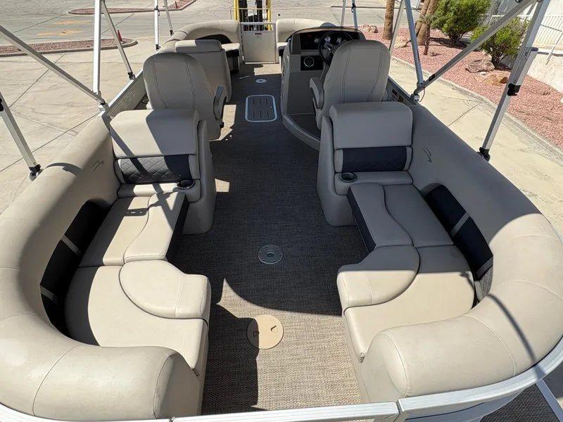 Slide: The Image of 2019 Bennington 23 SXP pontoon boat interior with beige seating and spacious layout. - 6