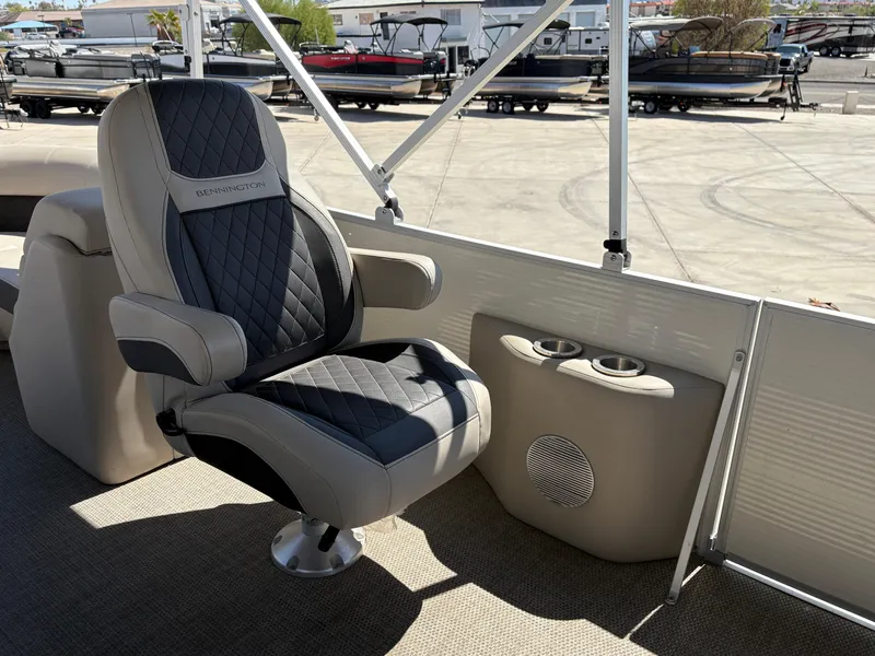 Slide: The Image of 2019 Bennington 23 SXP boat interior with luxury captain's chair and cup holders. - 7