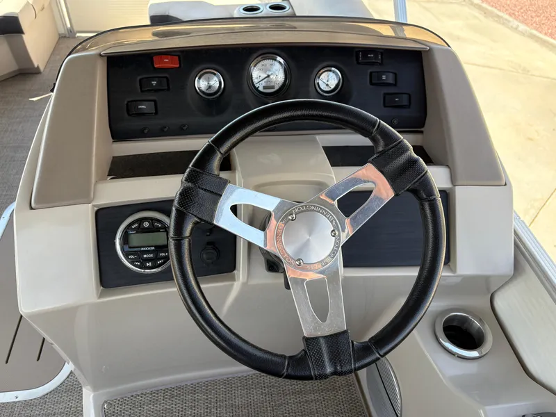 Slide: The Image of Steering console of a 2019 Bennington 23 SXP boat with gauges and controls. - 8