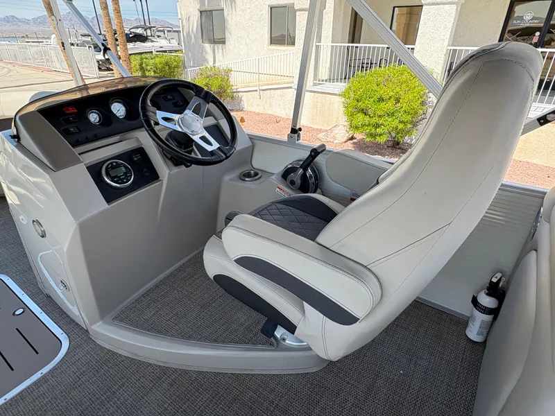 Slide: The Image of 2019 Bennington 23 SXP boat helm with steering wheel and captain's chair. - 9