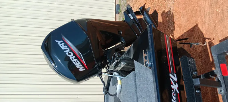 Slide: The Image of 2025 Tracker Bass Tracker Classic XL with Mercury outboard motor, parked on a trailer. - 11