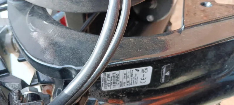 Slide: The Image of Close-up of a 2025 Tracker Bass Tracker Classic XL engine component with label and wiring. - 12