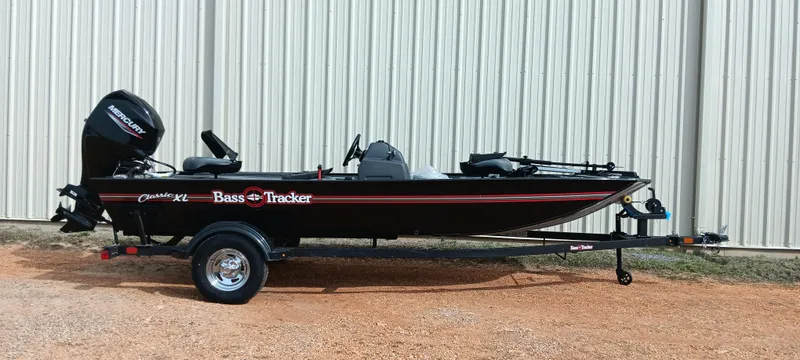Slide: The Image of 2025 Tracker Bass Tracker Classic XL boat on trailer, parked outdoors. - 13