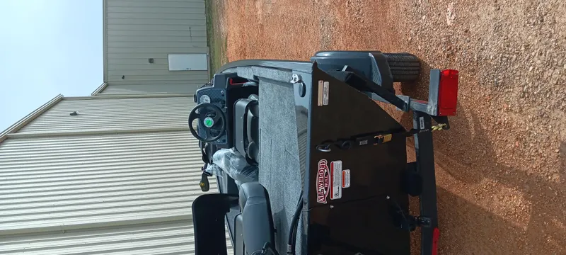 Slide: The Image of 2025 Tracker Bass Tracker Classic XL boat on a trailer, parked on gravel. - 15