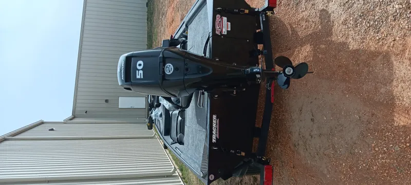 Slide: The Image of 2025 Tracker Bass Tracker Classic XL boat with 50 HP engine on a trailer. - 18