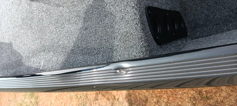 Slide: The Image of 2025 Tracker Bass Tracker Classic XL with dented side panel and carpeted interior. - 19