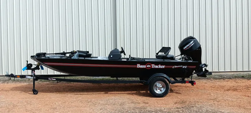 Slide: The Image of 2025 Tracker Bass Tracker Classic XL boat on trailer, parked outdoors. - 24