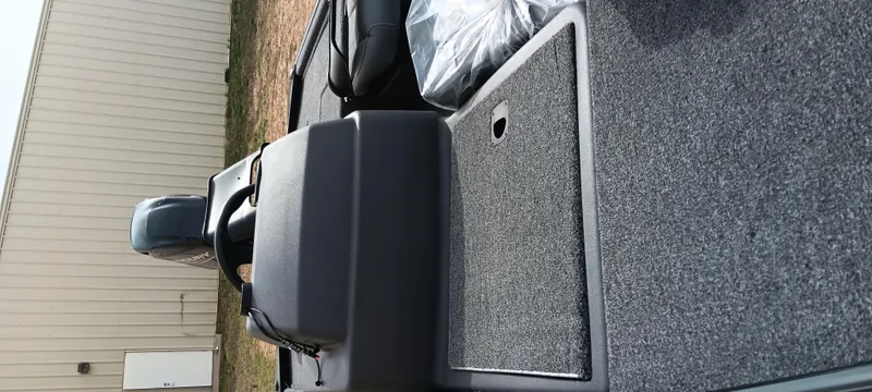 Slide: The Image of 2025 Tracker Bass Tracker Classic XL boat interior with carpeted deck and motor. - 29