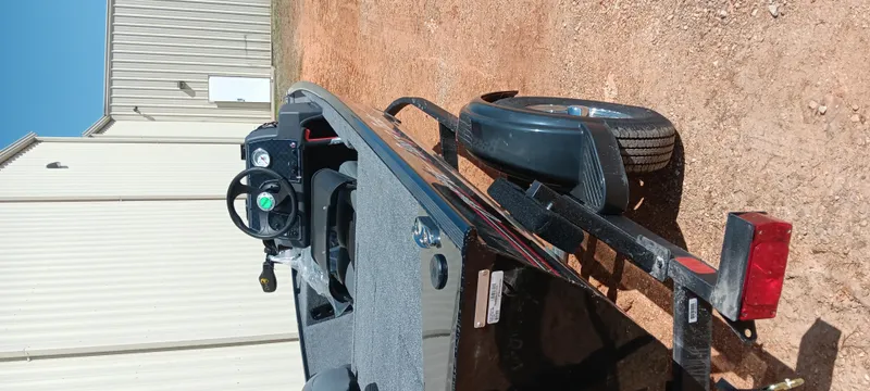 Slide: The Image of 2025 Tracker Bass Tracker Classic XL boat on trailer, parked on dirt near a building. - 3