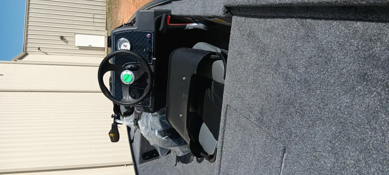 Slide: The Image of 2025 Tracker Bass Tracker Classic XL boat interior with steering wheel and seating. - 5