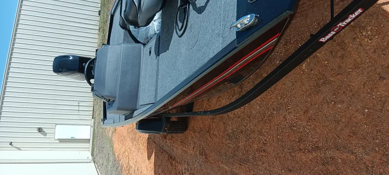 Slide: The Image of 2025 Tracker Bass Tracker Classic XL boat on a trailer, parked on gravel. - 7