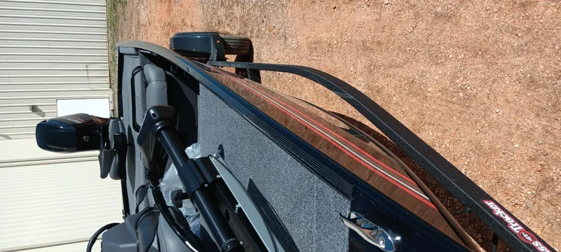 Slide: The Image of 2025 Tracker Bass Tracker Classic XL boat on a dirt surface, showcasing its sleek design. - 8