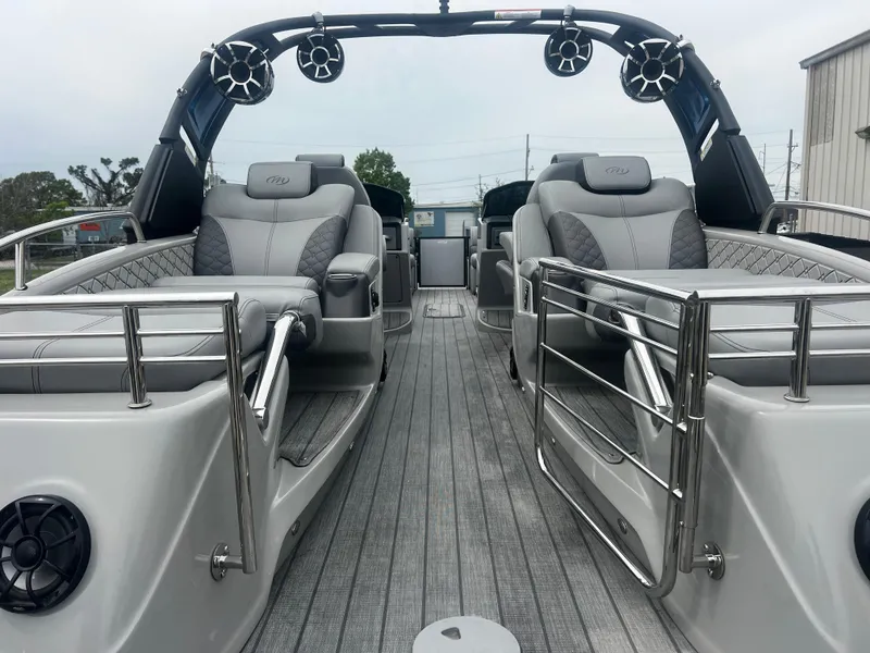 Slide: The Image of 2022 Manitou 27 boat interior with luxurious seating and sleek design. - 10