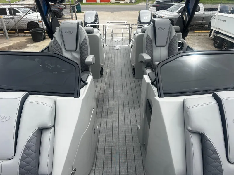 Slide: The Image of 2022 Manitou 27 boat interior with sleek seating and modern design. - 3