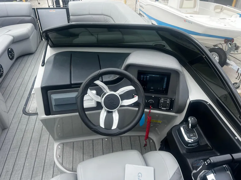 Slide: The Image of Cockpit of 2022 Manitou 27 boat with modern steering and controls. - 6