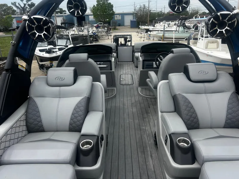 Slide: The Image of Luxurious 2022 Manitou 27 boat interior with plush seating and modern design. - 8