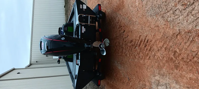 Slide: The Image of 2025 Ranger RT188C boat on dirt, rear view with motor and propeller. - 10