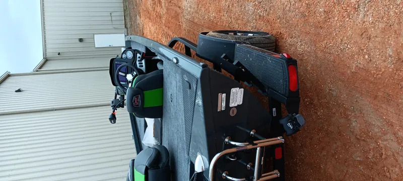 Slide: The Image of 2025 Ranger RT188C boat on trailer, parked on dirt near a building. - 12